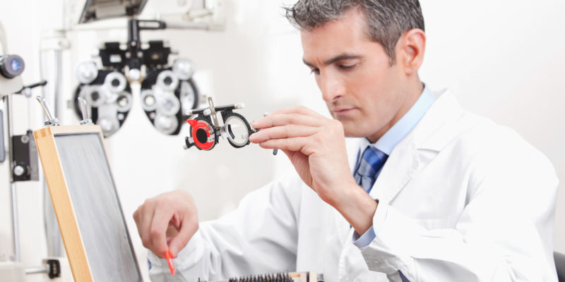 Optometrist Holding Measuring Eye Glasses